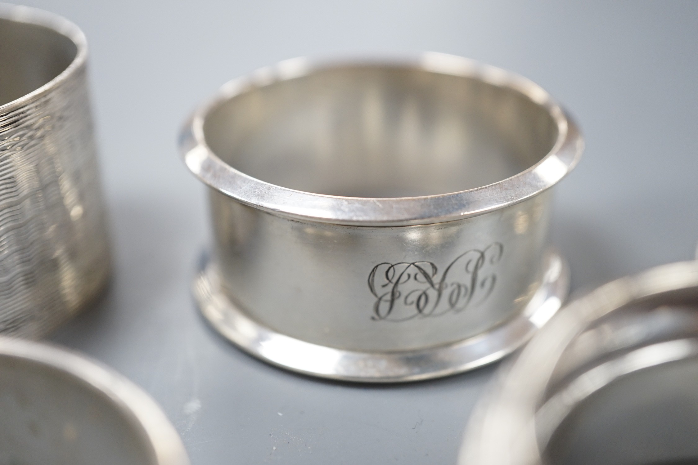 Seven assorted 20th century silver napkin rings, 121 grams.
